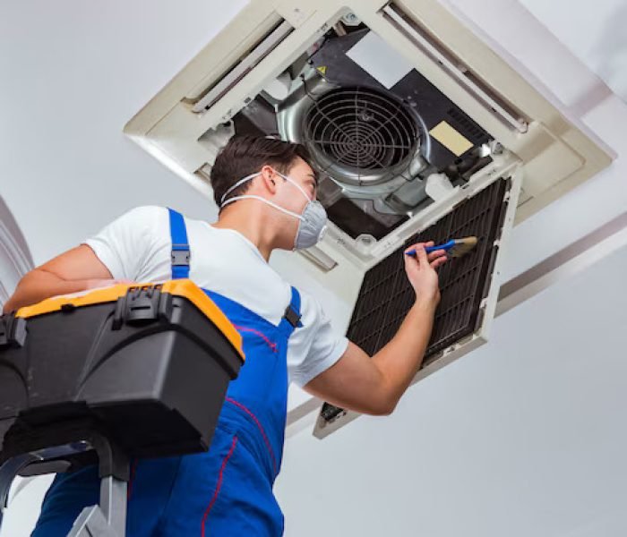 worker-repairing-ceiling-air-conditioning-unit_85869-7023
